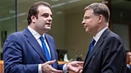 Eurogroup President Kyriakos Pierrakakis, left, speaks with European Commissioner for Economy Valdis Dombrovskis in Brussels.