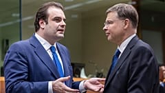 Eurogroup President Kyriakos Pierrakakis, left, speaks with European Commissioner for Economy Valdis Dombrovskis in Brussels.