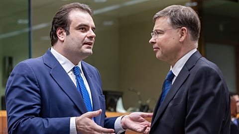 Eurogroup President Kyriakos Pierrakakis, left, speaks with European Commissioner for Economy Valdis Dombrovskis in Brussels.
