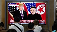 A TV screen shows a file image of North Korean leader Kim Jong Un and U.S. President Donald Trump during a news program at Seoul Railway Station in Seoul, South Korea.