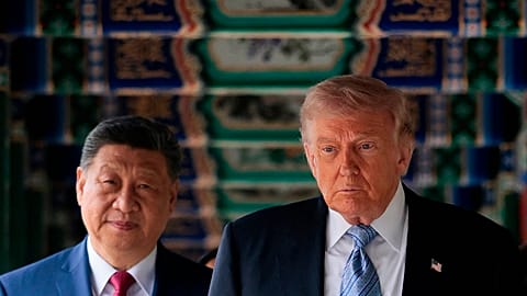 FILE. US President Donald Trump participates in a friendship walk through Zhongnanhai Garden with Chinese President Xi Jinping in Beijing, 15 May 2026