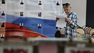 A voter holds her ballot before voting in the parliamentary elections in Vladivostok, Russia, on Friday, 18 September 2026.