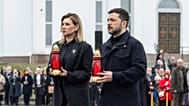 Volodymyr Zelenskyy and his wife Olena Zelenska carry candles to honour the memory of the victims of the Russian occupation  at a memorial in the town of Bucha.