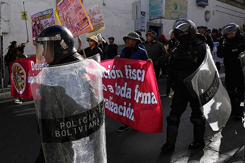 Police escort teachers during an anti-government protest in La Paz, Bolivia, Tuesday, Sept. 15, 2026