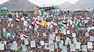 Supporters of Yemen’s Houthi rebels raise Yemeni, Lebanese and Iranian flags during a rally in support of the group.