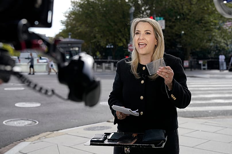 CNN White House Reporter Betsy Klein holding up an empty card holder after having her credential confiscated following Trump's ban, Saturday, Sept. 19, 2026, in Washington