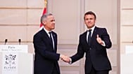 President of France Emmanuel Macron, right, gives a thumbs up as he shakes hands with Canada Prime Minister Mark Carney after delivering a joint statement at the Palais de l'E