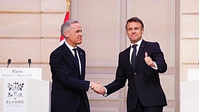 President of France Emmanuel Macron, right, gives a thumbs up as he shakes hands with Canada Prime Minister Mark Carney after delivering a joint statement at the Palais de l'E