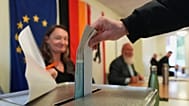 A man casts his ballots for the Berlin state election in Berlin, Germany, Sunday, Sept. 20, 2026.