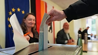A man casts his ballots for the Berlin state election in Berlin, Germany, Sunday, Sept. 20, 2026.