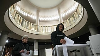 A voter casts a ballot in the parliamentary election in Moscow, Sunday, Sept. 20, 2026.