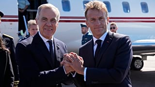 French President Emmanuel Macron, right, greets Canadian Prime Minister Mark Carney as he arrives in Saint-Pierre, Saint-Pierre-et-Miquelon, Sunday, Sept. 20,