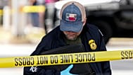 Immigration and Customs Enforcement officers stand at the scene where a man was shot in his vehicle by an ICE officer, in Austin, Texas. 21 September 2026