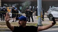 Immigration and Customs Enforcement officers stand at the scene where a man was shot in his vehicle by an ICE officer, in Austin, Texas. 21 September 2026