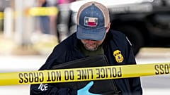 Immigration and Customs Enforcement officers stand at the scene where a man was shot in his vehicle by an ICE officer, in Austin, Texas. 21 September 2026