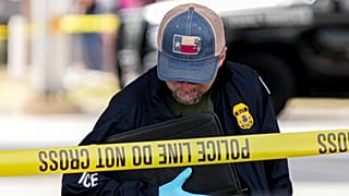 Immigration and Customs Enforcement officers stand at the scene where a man was shot in his vehicle by an ICE officer, in Austin, Texas. 21 September 2026