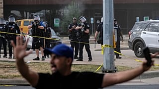 Immigration and Customs Enforcement officers stand at the scene where a man was shot in his vehicle by an ICE officer, in Austin, Texas. 21 September 2026