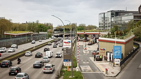 File - Vehicles pass by an Essence gas station of French oil and gas company TotalEnergies along Paris' ring road, Sunday, April 5, 2026. 