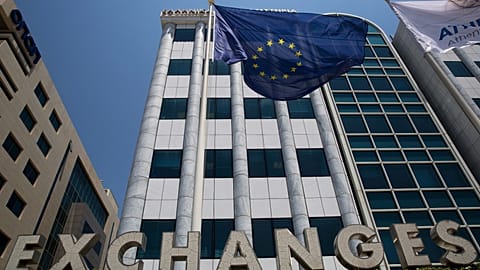 File - A European flag flutters outside the building of the Stock Exchange, in Athens, Friday, 24 June 2016.