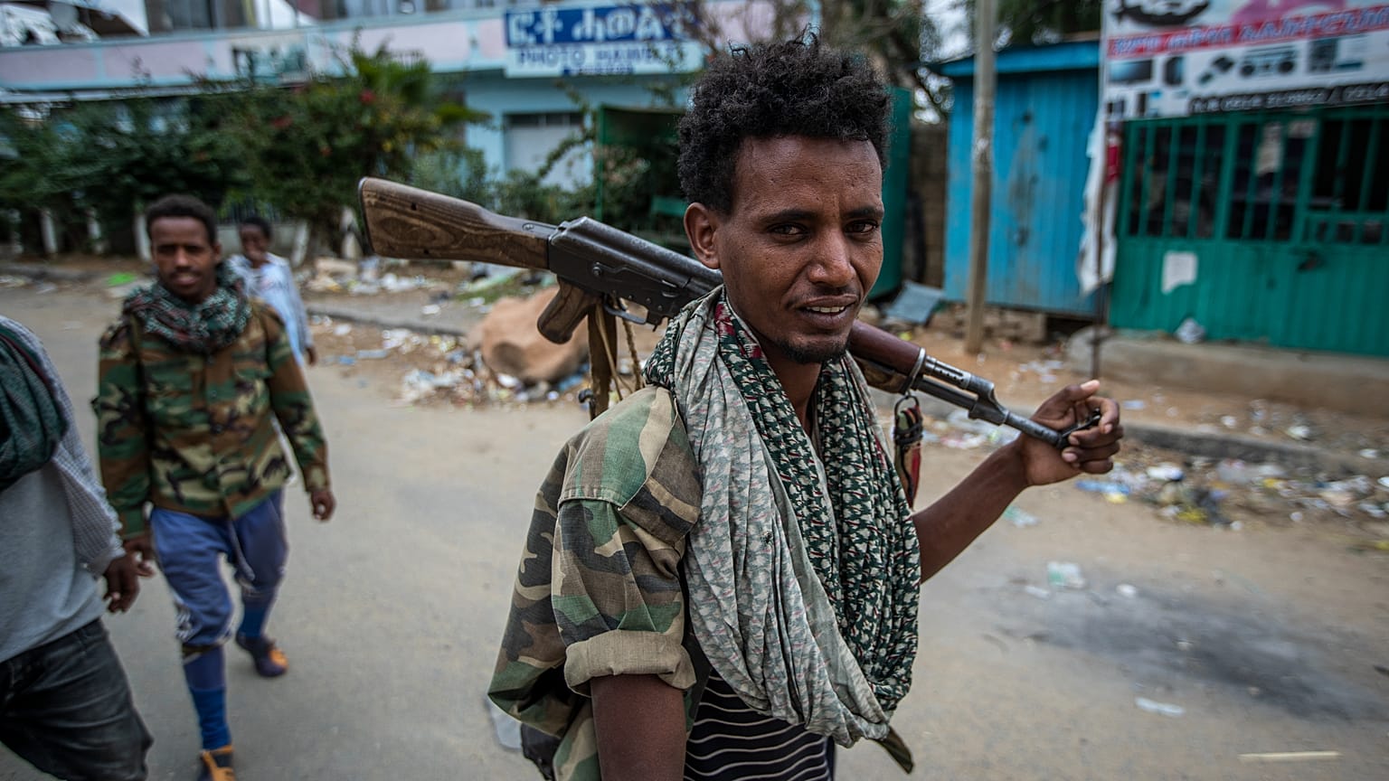 FILE: Fighters loyal to the Tigray People's Liberation Front (TPLF) walk along a street in the town of Hawzen in the Tigray region of northern Ethiopia, 7 May 2021