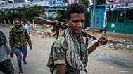 FILE: Fighters loyal to the Tigray People's Liberation Front (TPLF) walk along a street in the town of Hawzen in the Tigray region of northern Ethiopia, 7 May 2021