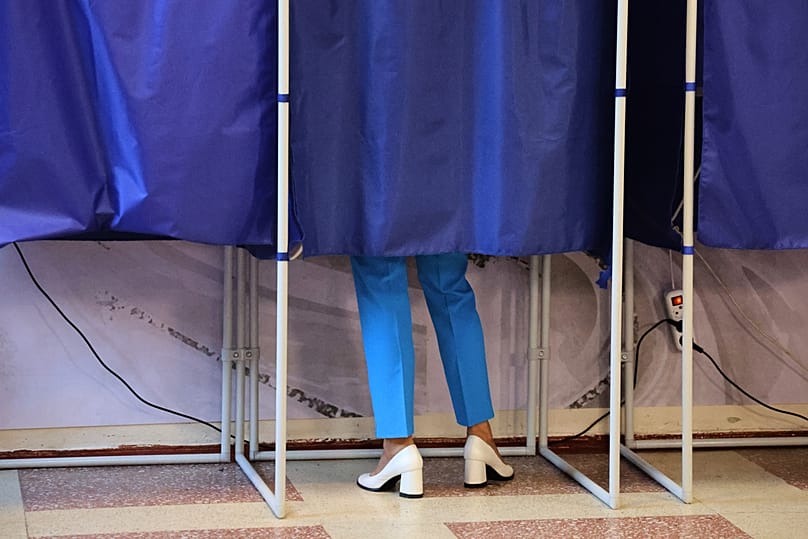A voter fills-in a ballot during Russia's parliamentary election in Donetsk, in the Russian-controlled part of the Donetsk region, Ukraine, Friday, Sept. 18, 2026. 