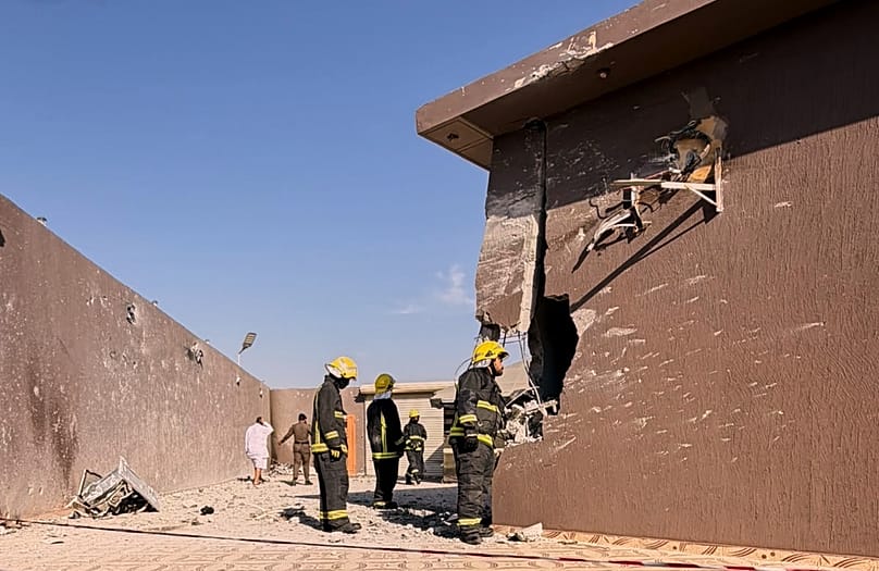 Firefighters inspect damage caused by falling debris from a drone that Saudi authorities say was launched by the Houthis over Taif province, 17 September, 2026