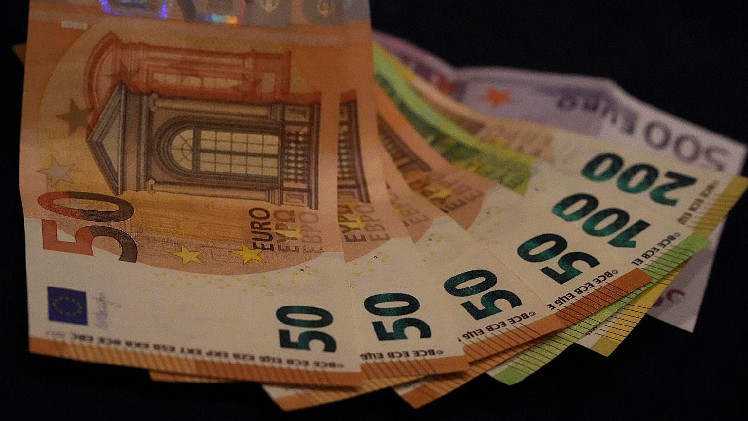 Euro banknotes lie on a table in Munich, Germany, on March 30, 2022