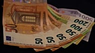 Euro banknotes lie on a table in Munich, Germany, on March 30, 2022
