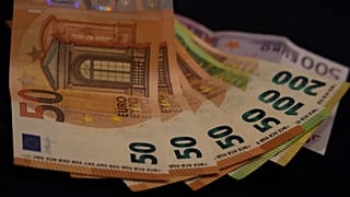 Euro banknotes lie on a table in Munich, Germany, on March 30, 2022