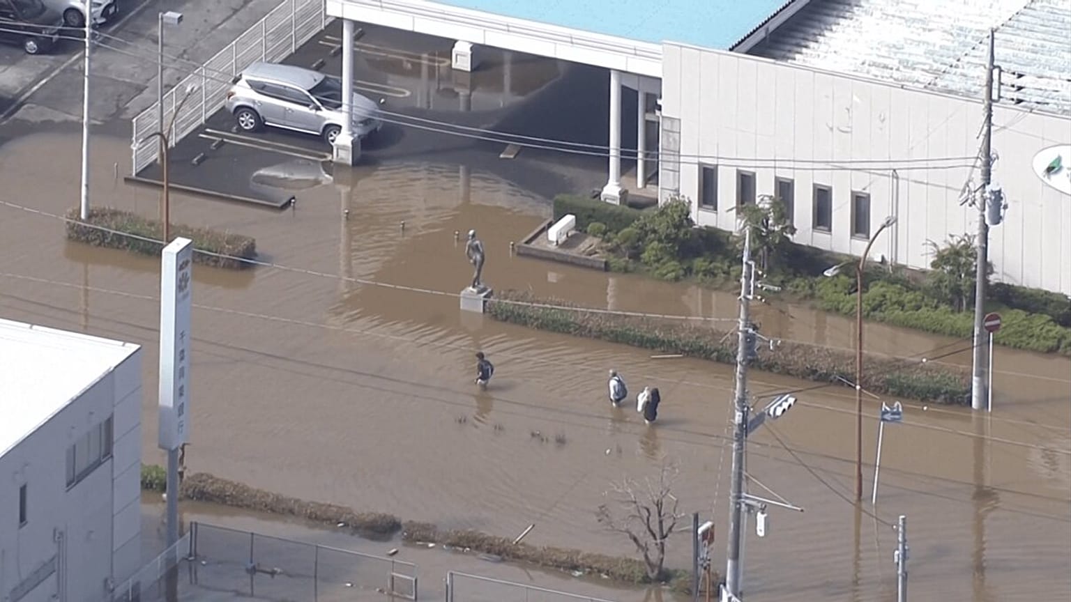 People wade through hip-deep floods a day after Typhoon Dujuan made landfall in Japan, triggering landslides, torrential rains, major floods, Chiba, Japan, 22 September, 2026