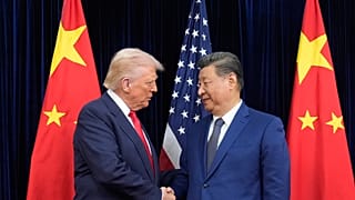 President Donald Trump, left, and Chinese President Xi Jinping, right, shake hands before their meeting at Gimhae International Airport in Busan, South Korea, Oct. 30, 2025.