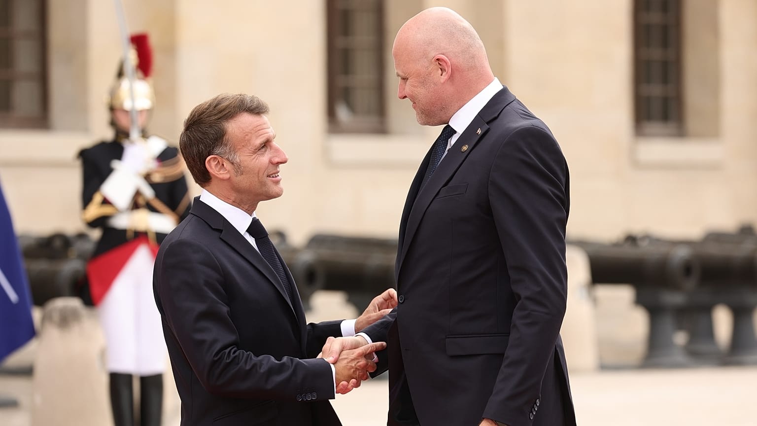 French President Emmanuel Macron, left, greets Latvian Prime Minister Andris Kulbergs ahead of the Coalition of the Willing summit 