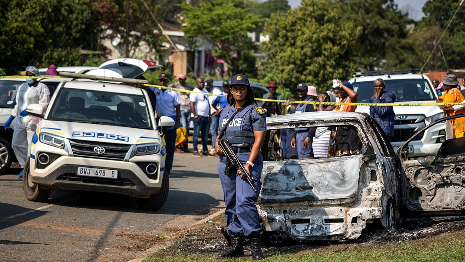 A police officer stands at the scene of a mass shooting at a house party in KwaMakhutha township south of Durban, 23 September, 2026