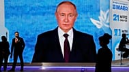 FILE: People walk past a screen with an image of Russian President Vladimir Putin at an exhibition at the St Petersburg International Economic Forum, 4 June 2026