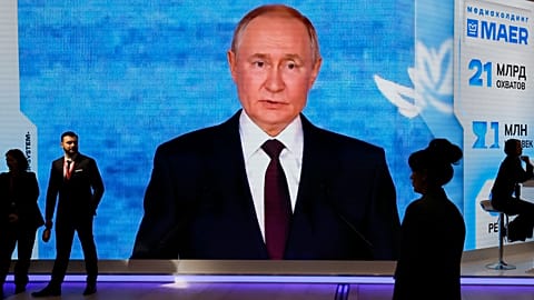 FILE: People walk past a screen with an image of Russian President Vladimir Putin at an exhibition at the St Petersburg International Economic Forum, 4 June 2026