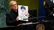 Iran's President Masoud Pezeshkian holds an image of late Ayatollah Ali Khamenei during the 81st session of the General Assembly at UN headquarters, 23 September 2026