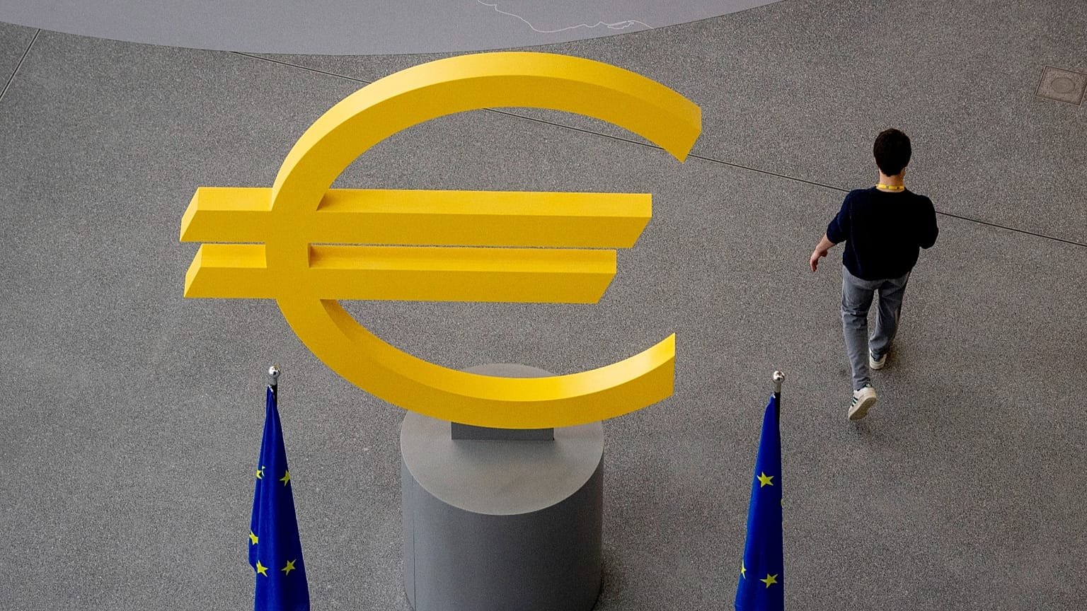A man walks past a Euro sign in the hallway of the European Central Bank after a meeting of the ECB's governing council in Frankfurt, Germany, Thursday, June 6, 2024. 