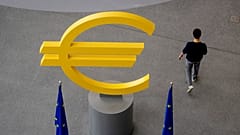 A man walks past a Euro sign in the hallway of the European Central Bank after a meeting of the ECB's governing council in Frankfurt, Germany, Thursday, June 6, 2024. 