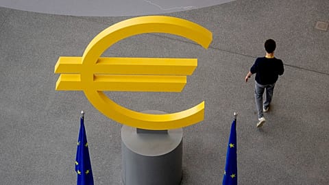 A man walks past a Euro sign in the hallway of the European Central Bank after a meeting of the ECB's governing council in Frankfurt, Germany, Thursday, June 6, 2024. 