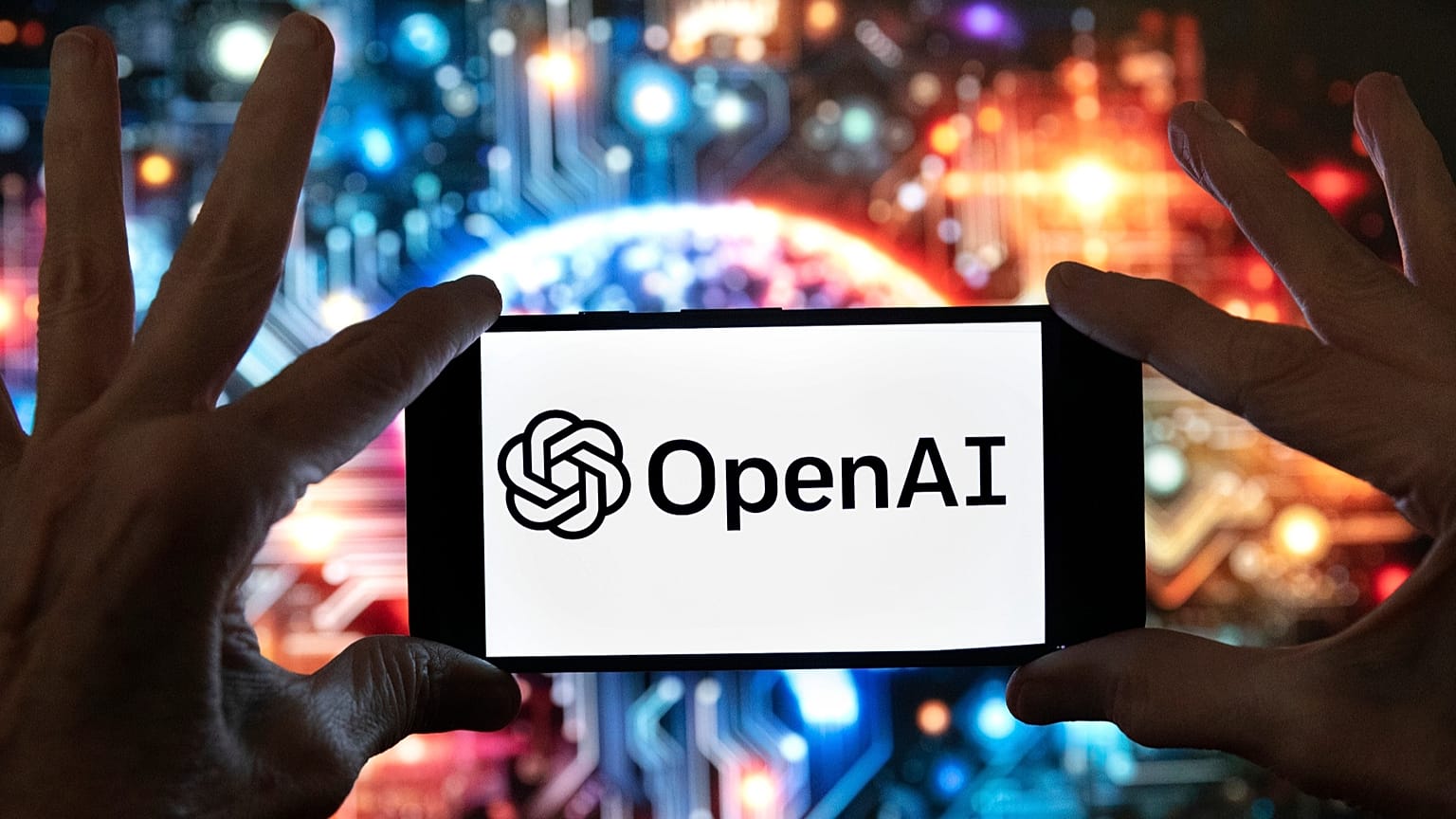 The OpenAI logo is displayed on a mobile phone in Boston, 8 December, 2023