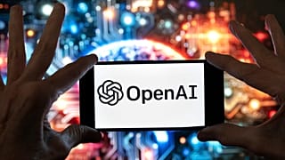 The OpenAI logo is displayed on a mobile phone in Boston, 8 December, 2023