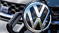 File - An e-Golf car is fixed with a charging station during a press tour at the plant of the German manufacturer Volkswagen AG (VW) in Zwickau, Germany. 14 May 2019.