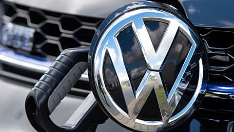 File - An e-Golf car is fixed with a charging station during a press tour at the plant of the German manufacturer Volkswagen AG (VW) in Zwickau, Germany. 14 May 2019.
