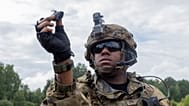 A US Army Soldier prepares to launch his Black Hornet micro drone.
