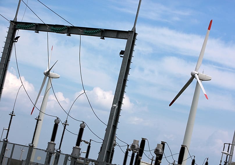 Wind power generators are seen through an electric station near the village of Bozhurec east of Sofia, 6 April, 2010