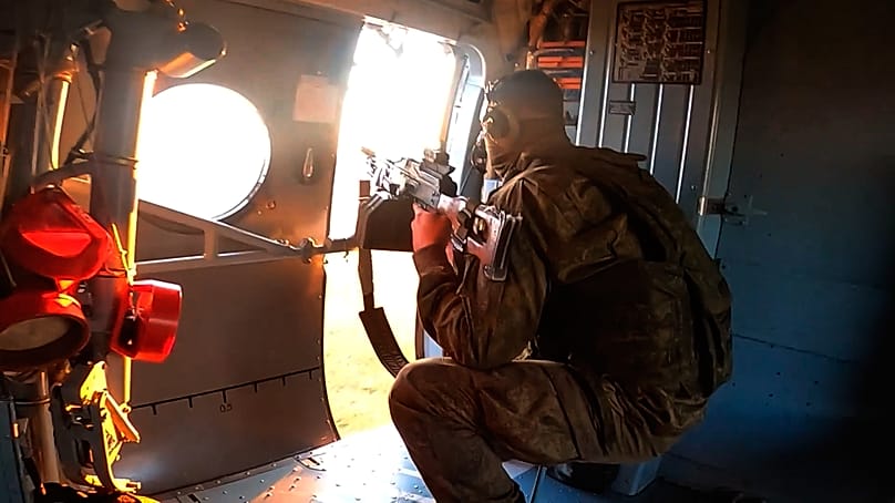 A Russian Army soldier controls an area from a board of military helicopter in an undisclosed location in Ukraine, 9 July, 2026