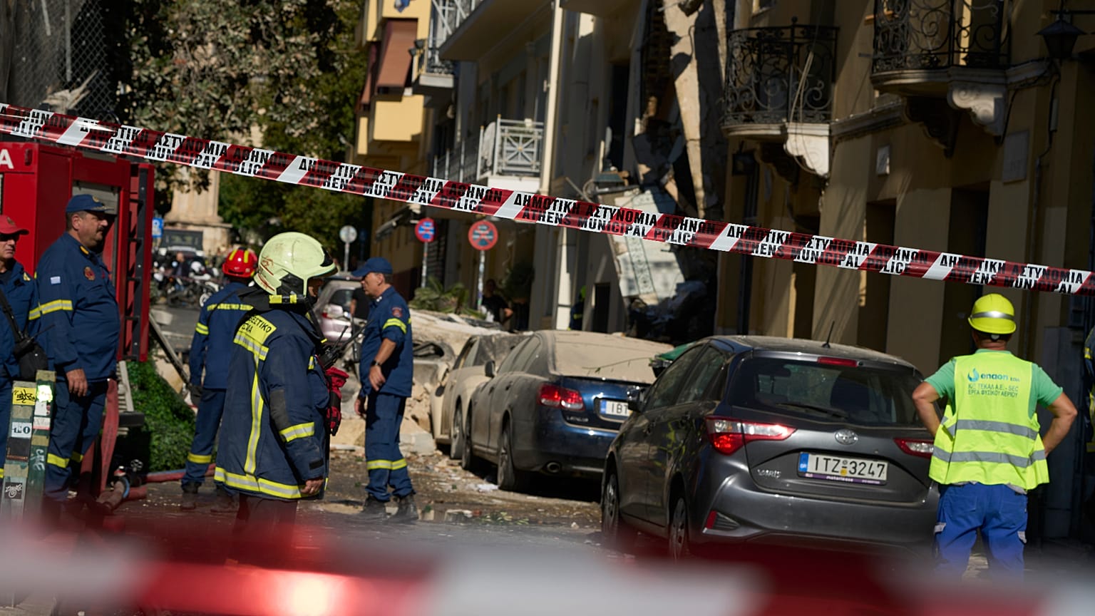 Firefighters work at the scene following a powerful blast that caused a building to collapse and injured at least two people in Athens
