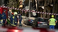Firefighters work at the scene following a powerful blast that caused a building to collapse and injured at least two people in Athens