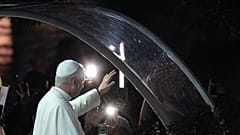 Pope Leo XIV waves to the crowd on his way for a prayer at the Grotto of the Apparitions of Massabielle, in Lourdes, France, Saturday, Sept. 26, 2026. (AP Photo/Laurent Cipria